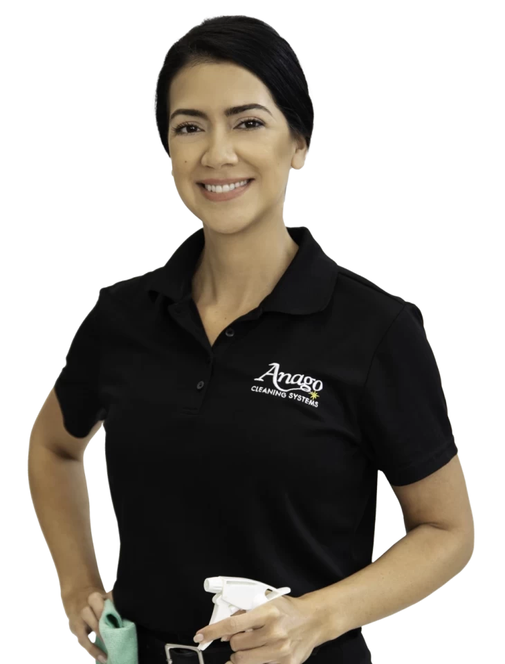 Smiling Anago franchisee holding a spray bottle and cleaning cloth